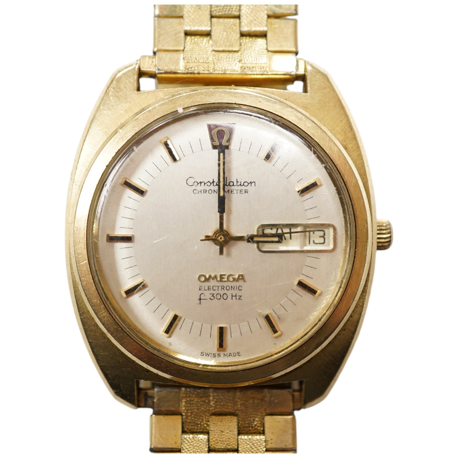 A gentleman's steel and gold plated Omega Constellation Electronic wrist watch, with baton numerals and day/date aperture, case diameter 38mm, on an associated gold plated strap. Condition - poor